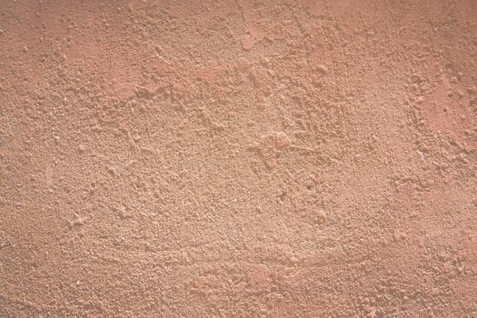 Red terracotta background texture closeup toned in trend color Living Coral.