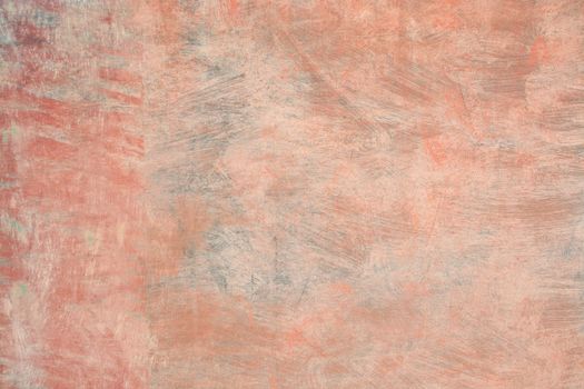 Grungy roughcast wall texture scratchy background in reds, oranges and greens toned in trend color Living Coral.