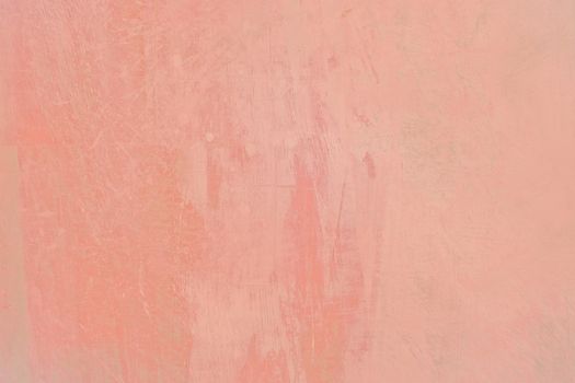 Grungy red roughcast wall scratchy background texture toned in trend color Living Coral.