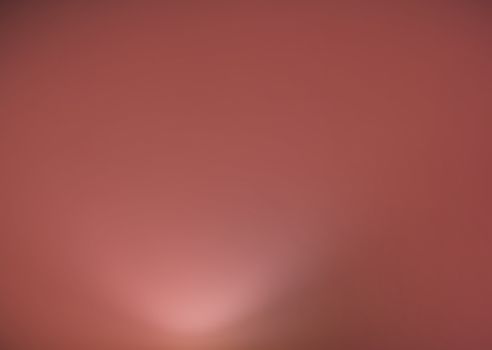 Light from below on violet soft color wall interior background toned in trend color Living Coral.