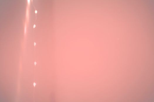 String of lights margin and wall background toned in Living Coral shades