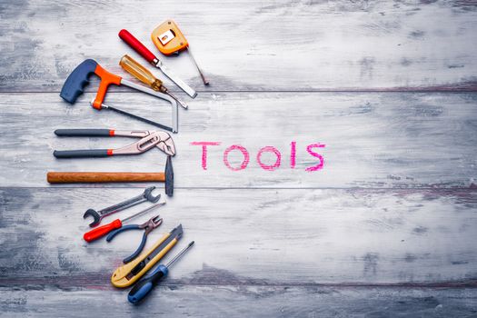 Set of work tool on rustic wooden background with written "tools" in space, industry engineer tool concept.still-life.