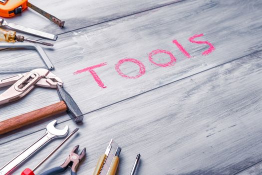 Set of work tool on rustic wooden background with written "tools" in space, industry engineer tool concept.still-life.