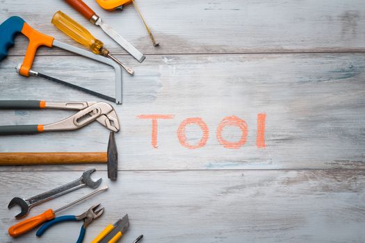 Set of work tool on rustic wooden background with written "tool" in space, industry engineer tool concept.still-life.close up.