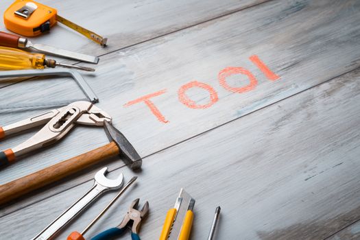 Set of work tool on rustic wooden background with written "tool" in space, industry engineer tool concept.still-life.