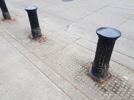 black bollard or post and street or road with grey cement