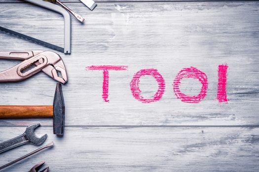 Set of work tool on rustic wooden background with written "tool" in space, industry engineer tool concept.still-life.close up.