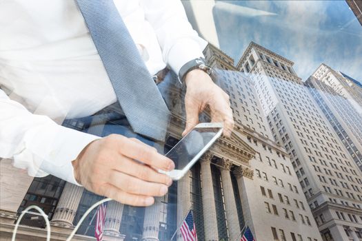 Close up of a businessman using smart phone trading app while driving on the back seat of a car. Focus on mobile device. New York stock exchange reflection can be seen in the window.