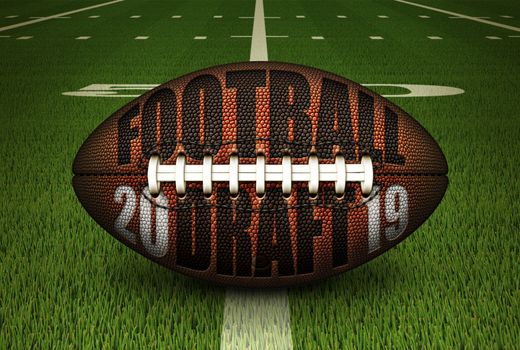 Illustration of a football with FOOTBALL DRAFT and 2019 embossed onto it; stting on the 50 yard line. 3D Illustration