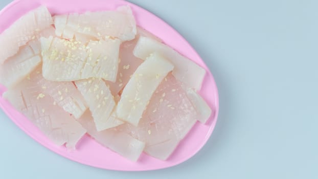top view raw squid sliced on pink plate