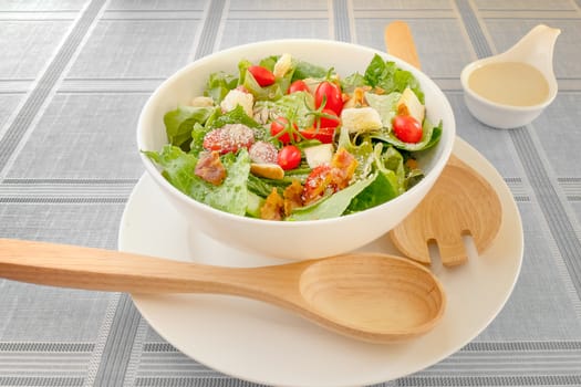 fresh organic salad in white bowl served with cream sauce