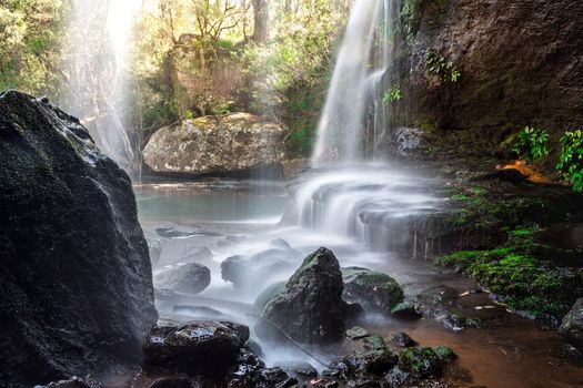 Waterfall cascades over rock ledges as it meanders through beautiful Australian bushland