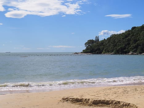 Summer landscape with deserted beach, sunny, in sunny day, with sea and cable in the background