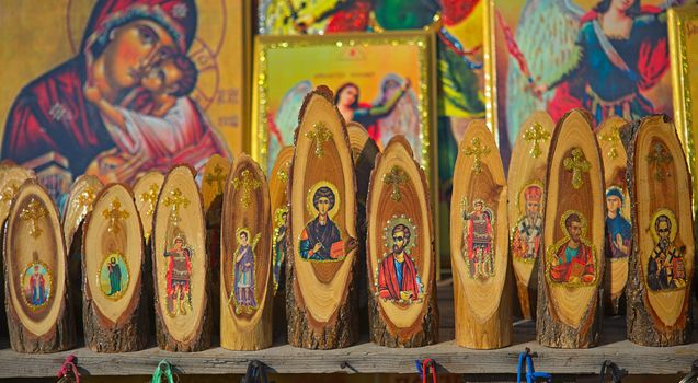 Various orthodox christian wooden carvings and icons on display at market for sale