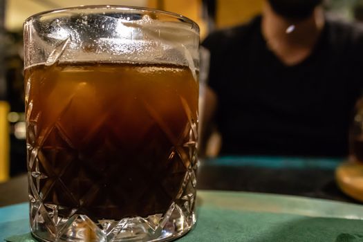 a closeup side view shoot of a cup of iced coffee. photo has taken from a cafe at izmir/turkey.