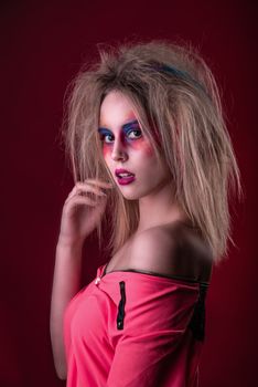 Emotional Portrait of a Attractive young girl with carnival colorful makeup and disheveled hair