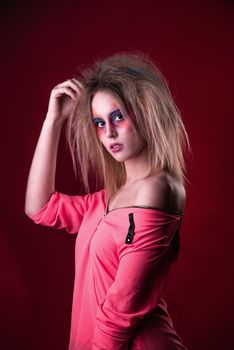 Emotional Portrait of a Attractive young girl with carnival colorful makeup and disheveled hair