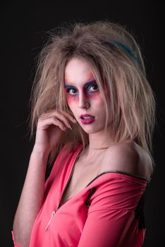 Emotional Portrait of a Attractive young girl with carnival colorful makeup and disheveled hair