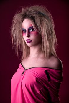Emotional Portrait of a Attractive young girl with carnival colorful makeup and disheveled hair