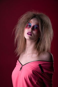 Emotional Portrait of a Attractive young girl with carnival colorful makeup and disheveled hair