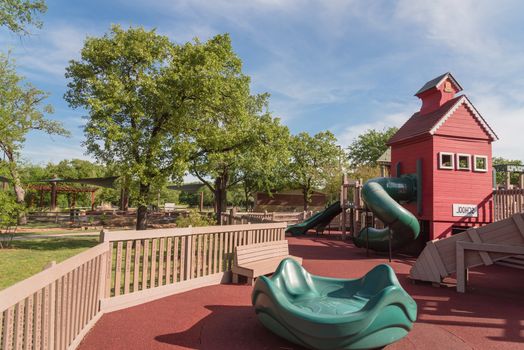 Wooden playground, castle-inspired structure with soft rubber surface near Dallas, Texas, USA