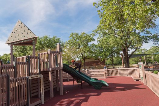 Wooden playground, castle-inspired structure with soft rubber surface near Dallas, Texas, USA