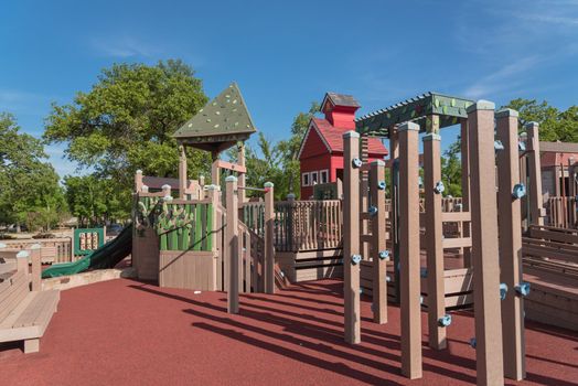 Wooden playground, castle-inspired structure with soft rubber surface near Dallas, Texas, USA