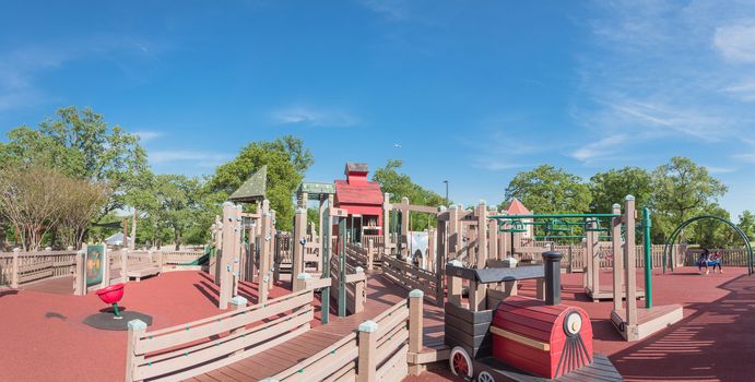 Panorama view castle-inspired structure, elaborate wooden playground with soft rubber surface near Dallas, Texas, USA