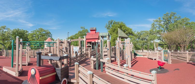 Panorama view castle-inspired structure, elaborate wooden playground with soft rubber surface near Dallas, Texas, USA