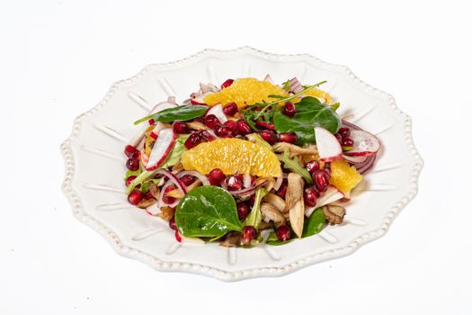 Porcelain plate with salad on an isolated studio background