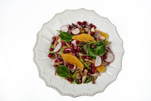 Porcelain plate with salad on an isolated studio background