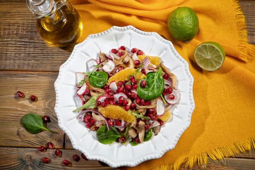 Plate with salad on a wooden desk and fabric