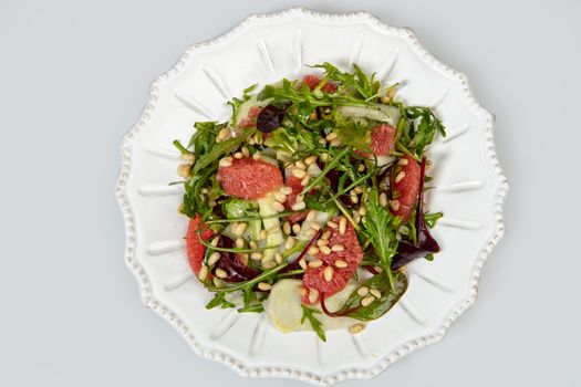 Porcelain plate with salad on an isolated studio background
