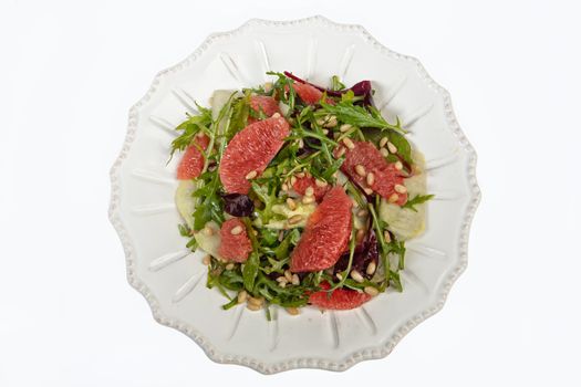 Porcelain plate with salad on an isolated studio background