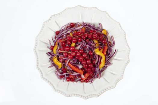 Porcelain plate with salad on an isolated studio background