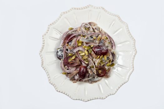 Porcelain plate with salad on an isolated studio background