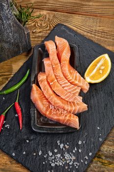 Red fish and limes on an old wooden desk