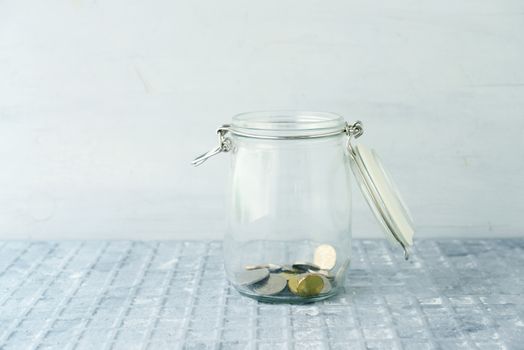 Coins in glass money jar, financial concept. 