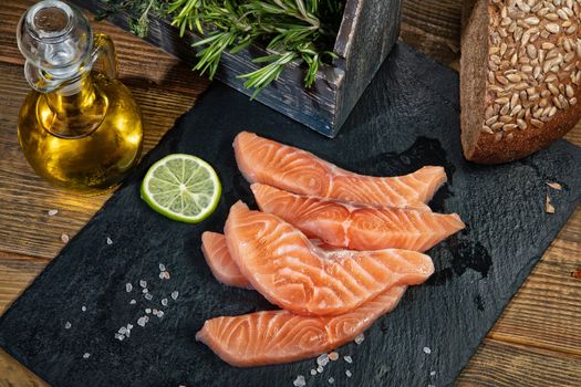 Red fish and limes on an old wooden desk