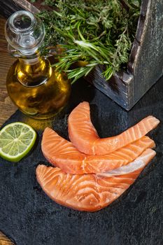 Red fish and limes on an old wooden desk