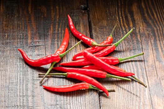 Pile of Mexican chili peppers on wooden background. Fiery seasoning