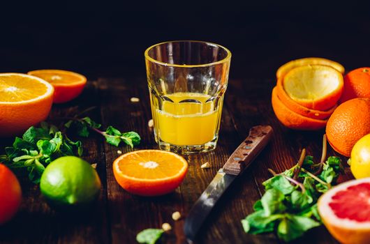Fresh Citrus Juice in Glass and Sliced Fruits.