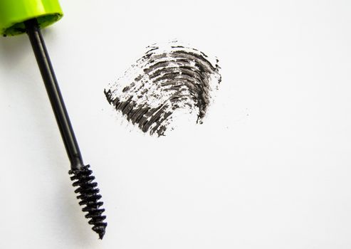 Black ink smear and green brush isolated on white.