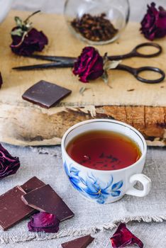 Cup of Tea with Chocolate Bar and Rose Buds.
