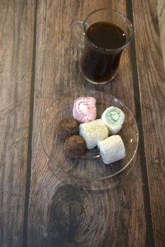 Turkish coffee with Turkish delight on white wooden background close-up