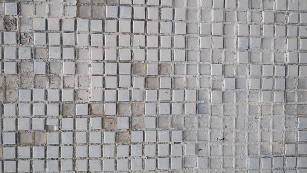 Old wall with a partly showered mosaic. Background, texture.