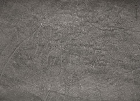 Decorative surface imitating artificially made leather. The picture was taken in the daytime, closeup.