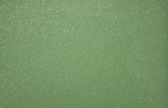 Green pearlescent transparent background with metal splashes. Background. Texture.