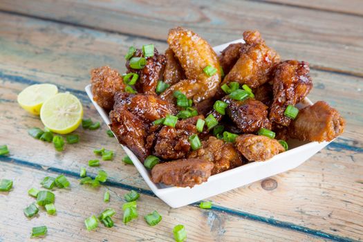 Lemon tantalising chicken wings in square bowl 