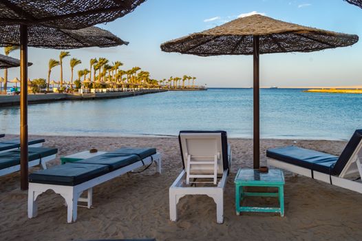 Deckchairs and parasols on a beach of the Red Sea in Hurghada Egypt